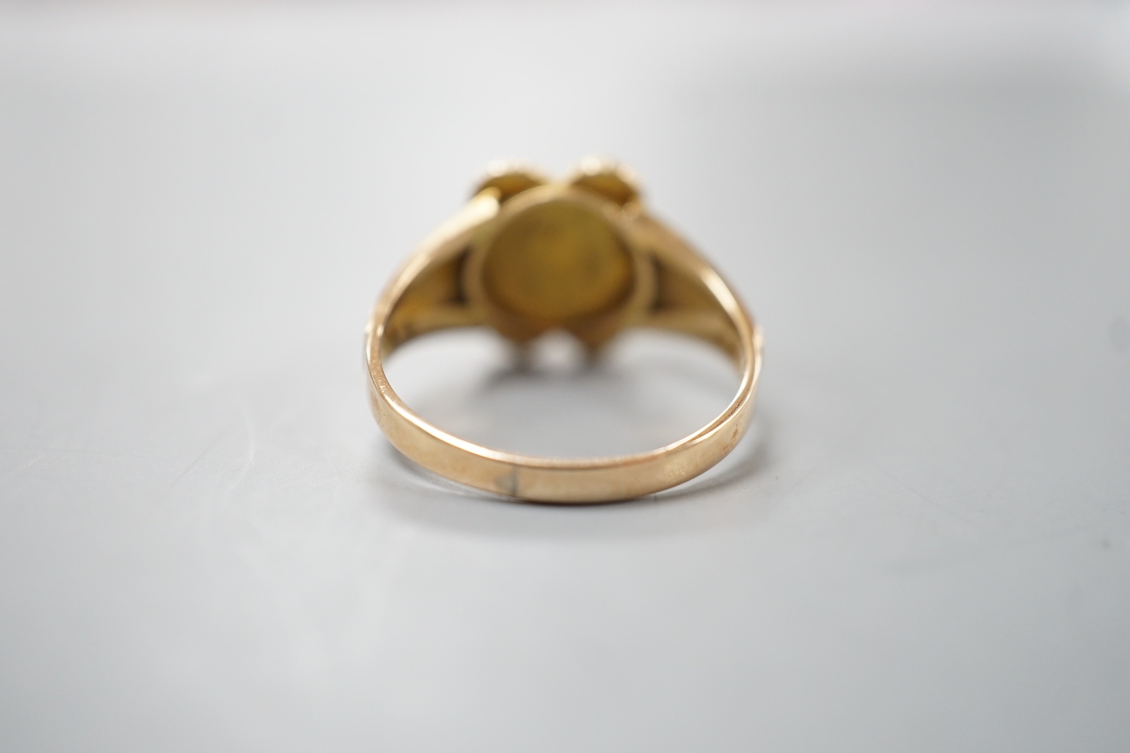 A late Victorian gold, emerald and split pearl cluster set ring, with later engraved inscription, size N, gross weight 2.9 grams.